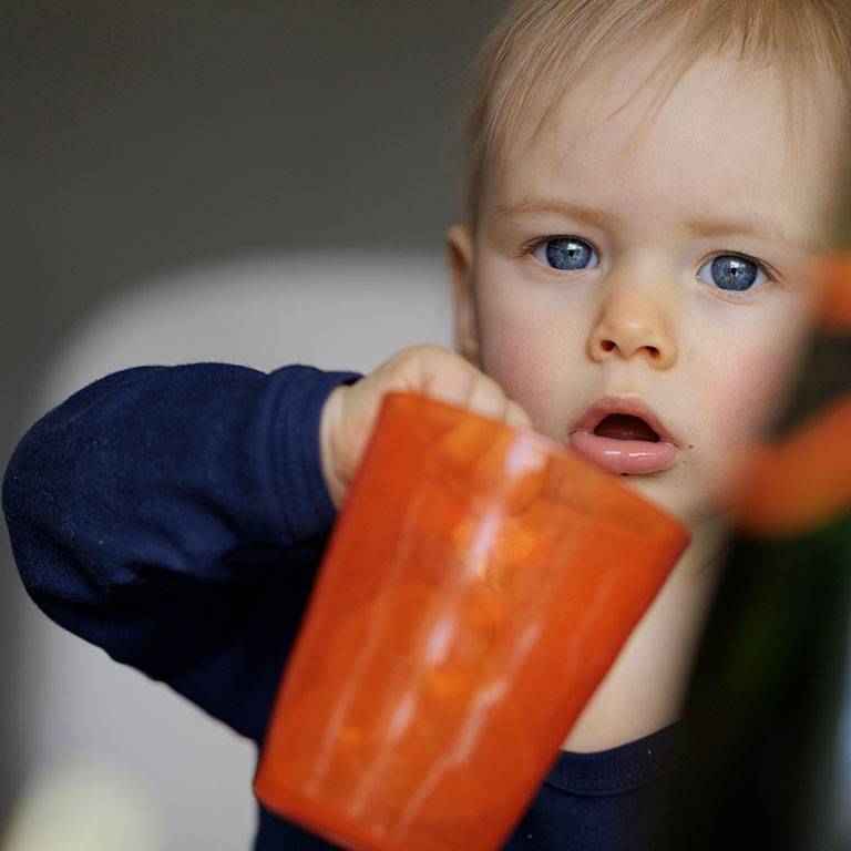bebe-blond-yeux-bleus-verre-orange
